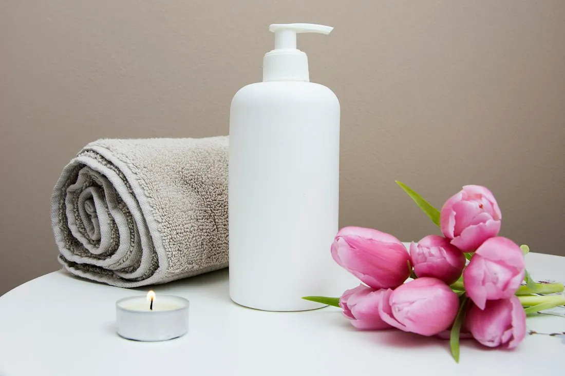 A towel, natural flowers and spa amenities illustrating the wellness experience